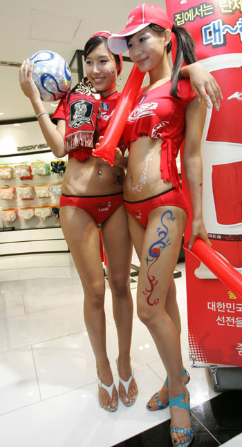 A South Korean model in underwear poses with a soccer ball at a fashion show held to wish the South Korean national soccer team success in the 2006 World Cup in Germany, in Seoul May 17, 2006. The panty was designed with a "Reds LOVE" slogan cheering the South Korean soccer team for the upcoming soccer event. [Reuters]