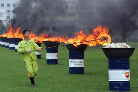 A military policeman lights up drugs at a university campus, three days before June 26, the International Day against Drug Abuse and Illicit Drug Trafficking in Shanghai June 23, 2006.