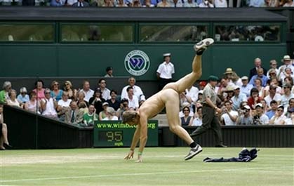 An unidentified streaker does a cartwheel, as he interrupts the Women's Singles quarter-final match between Maria Sharapova and Elena Dementieva, both of of Russia, on the Cemtre Court at Wimbledon, Tuesday, July 4, 2006. [AP Photo]