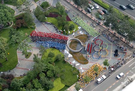 Chinese residents get together to celebrate the fifth anniversary of Beijing's successful bidding for 2008 Olympic Games in East City District, Beijing, July 13, 2006. Beijing currently holds the 4th Olympic Cultural Festival as part of 2008 Beijing Olympic Games awareness campaign.[Zhangxu/Xinhua]