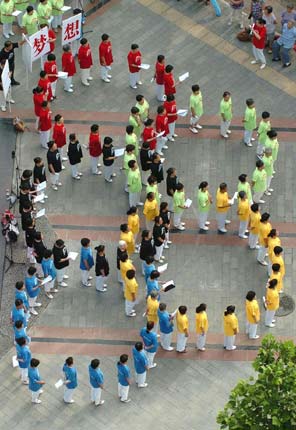 Chinese residents get together to celebrate the fifth anniversary of Beijing's successful bidding for 2008 Olympic Games in East City District, Beijing, July 13, 2006. Beijing currently holds the 4th Olympic Cultural Festival as part of 2008 Beijing Olympic Games awareness campaign.[Zhangxu/Xinhua]