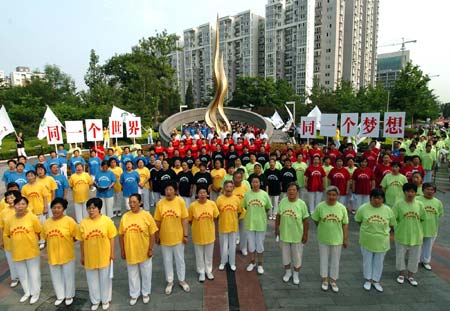 Chinese residents get together to celebrate the fifth anniversary of Beijing's successful bidding for 2008 Olympic Games in East City District, Beijing, July 13, 2006. Beijing currently holds the 4th Olympic Cultural Festival as part of 2008 Beijing Olympic Games awareness campaign.[Zhangxu/Xinhua]