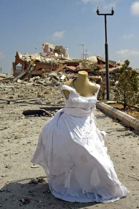 A mannequin adorned with a wedding dress stands near the site of an Israeli air raid in Qana July 31, 2006, where more than 54 women and children were killed a day earlier. International pressure for a swift ceasefire in Lebanon mounted on Monday, France and Germany saying Israel's partial pause in airstrikes was not enough and Russia calling for an immediate suspension of hostilities.[Reuters]