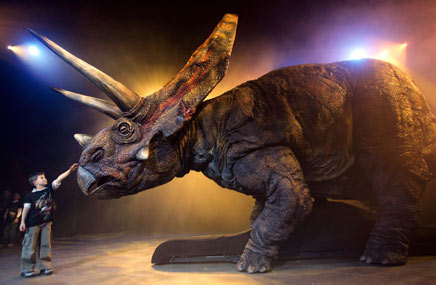 Members of the media watch a life-sized, walking model of a Torosaurus dinosaur as it performs during the world premiere of 'Walking With Dinosaurs - The Live Experience' in Sydney August 1, 2006. The A$12 million (US$9 million) show, based on the BBC television series 'Walking With Dinosaurs', will consist of 15 life-sized animatronic dinosaurs performing on stage. It will open to the public in January 2007, and will travel around the world later that year. [Reuters] 