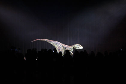 Members of the media watch a life-sized, walking model of a Torosaurus dinosaur as it performs during the world premiere of 'Walking With Dinosaurs - The Live Experience' in Sydney August 1, 2006. The A$12 million (US$9 million) show, based on the BBC television series 'Walking With Dinosaurs', will consist of 15 life-sized animatronic dinosaurs performing on stage. It will open to the public in January 2007, and will travel around the world later that year. [Reuters] 