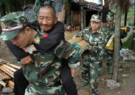 Chinese maritime police evacuate residents before the coming of Saomai in Wenzhou, East China's Zhejiang Province August 10 2006. At least 571,376 people in China -- 305,376 in Zhejiang and 266,000 in Fujian -- have been evacuated, from the path of Typhoon Saomai, which has upgraded to extremely powerful, Xinhua reported.[Xinhua] Detail