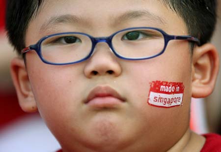 A Singaporean looks out from the stands during the National Day Parade in Singapore August 9, 2006. 