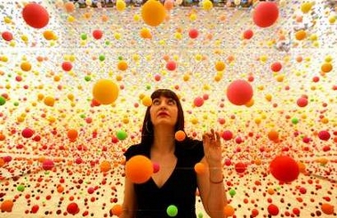 Australian artist Nike Savvas makes final adjustments to her art piece consisting of over 50,000 polystyrene balls at the New South Wales Art Gallery in Sydney August 3, 2006. The sculpture titled 'Atomix - Full of Love, Full of Wonder' , vibrates with wind from 10 fans and represents the different 'shimmering' colours in a hot, outback landscape. It is part of a sculpture exhibition 'Adventures with Form in Space' that will open to the public next week.