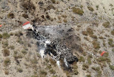 A general view of the wreckage of a helicopter which crashed near Iran's northern town of Amol August 11, 2006. Six people aboard the helicopter were killed when it crashed in Iran's Caspian Sea province of Mazandaran on Friday, an official told state television. The helicopter crashed into Damavand Mountain near Amol at around 06.00 a.m. (0230 GMT).[Reuters]