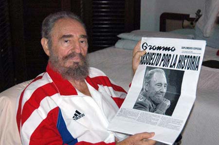Cuban leader Fidel Castro shows a copy of a newspaper in this undated photo released on August 13, 2006. A Cuban newspaper on Sunday published the first photographs of Fidel Castro since his stomach surgery and the Cuban leader said he had stabilized "considerably" but was not out of the woods.
