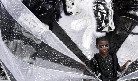 A carnival-goer in costume dances at the annual Notting Hill Carnival in London August 27, 2006. The carnival which began in 1964 and starts on Sunday is one of the world's largest street parties with thousands of people expected to attend over the Bank Holiday weekend.