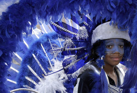 A carnival-goer in costume dances at the annual Notting Hill Carnival in London August 27, 2006. The carnival which began in 1964 and starts on Sunday is one of the world's largest street parties with thousands of people expected to attend over the Bank Holiday weekend. 