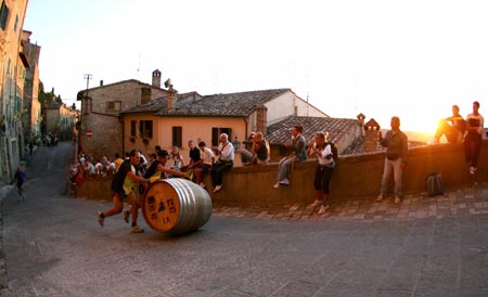 Lorenzo Martire (L) and Giovanni Zorn compete to win a wine barrel race in Montepulciano, near Siena, central Italy, September 3, 2006. The race, known as the Il Bravio delle Botti, is the highlight of a 10-day holiday dating back to the 14th century to celebrate Montepulciano's patron Saint John the Baptist, with costumed ceremonies, dance parties, street theatre performances and lavish parties served on the squares. Picture taken September 3, 2006. 