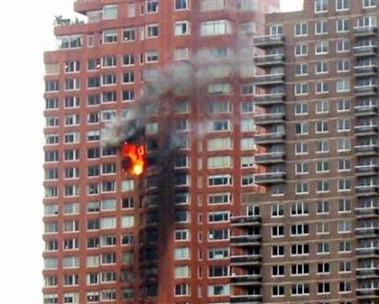 A high-rise building burns after a small aircraft crashed into the building in New York, October 11, 2006. 