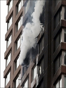 Smoke pours out of the side of an apartment building on the east side of Manhattan after being hit by a small plane in New York. US authorities scrambled fighter jets above US cities as a precaution after the plane crashed into the building, a top commander said.(
