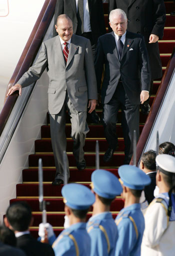 France's President Jacques Chirac (L) arrives at Beijing airport October 25, 2006. 