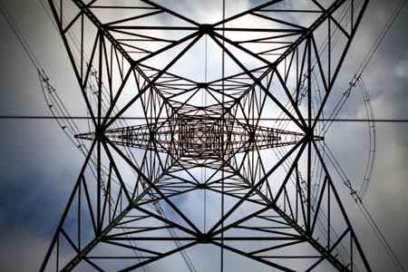 A high-voltage power line tower is pictured near Berlin, November 7, 2006. Europe wrung its hands on Monday over the root causes of widespread weekend blackouts, with Germany accusing utilities of slack investment and Brussels promising new measures to improve EU electricity transmission. Germany's E.ON said an overload of its northwest German high-voltage grid was responsible for the temporary power cuts. Klaus-Dieter Maubach, a board member at E.ON's central European energy marketing unit, appeared to confirm that the blackouts were triggered by the scheduled switching off of a line over the river Ems to allow a cruise ship to pass through.
