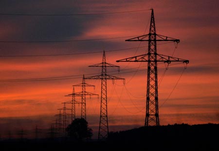 High-voltage power lines and electricity pylons are pictured during sunset near the southern German city of Ulm, November 7, 2006. Europe wrung its hands last Monday over the root causes of widespread weekend blackouts, with Germany accusing utilities of slack investment and Brussels promising new measures to improve EU electricity transmission. Germany's E.ON said an overload of its northwest German high-voltage grid was responsible for the temporary power cuts. Klaus-Dieter Maubach, a board member at E.ON's central European energy marketing unit, appeared to confirm that the blackouts were triggered by the scheduled switching off of a line over the river Ems to allow a cruise ship to pass through.