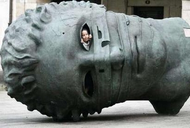 A girl looks out from a sculptural creation by the artist Igor Mitorac of Poland in a square in Vigo, northwest Spain, November 10, 2006. 