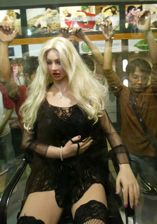 Visitors look at a life-size sex doll on display during the fourth Guangzhou ... Visitors look at a life-size sex doll on display during the fourth Guangzhou ...