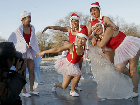 People dressed in Santa Claus costumes dance as they celebrate the upcoming Christmas Day at a park in Shenyang, capital of northeast China's Liaoning province December 23, 2006. 