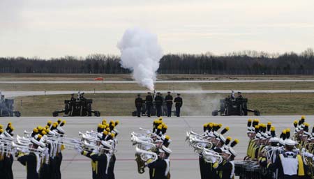 Military honor guards perform a 21-gun salute as the University of Michigan Marching Band plays during a ceremony to honor the late former U.S. President Gerald Ford at Gerald R. Ford International Airport in Grand Rapids, Michigan January 2, 2007. 