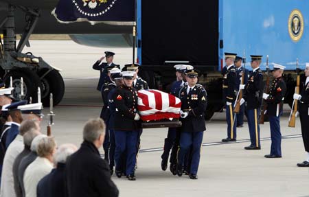 The casket of former U.S. President Gerald Ford is carried by military honor guards at Gerald R. Ford International Airport in Grand Rapids, Michigan January 2, 2007. 