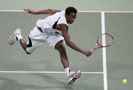 Gael Monfils of France returns the ball to Andreas Seppi of Italy during the Qatar Open tennis tournament in Doha January 1, 2007. 