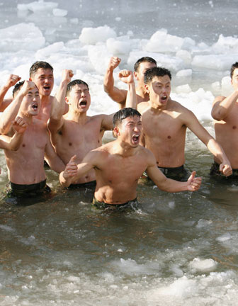 Members of the Special Warfare Command take a cold bath during an annual severe winter season drill in Pyongchang, about 180km (113 miles) east of Seoul, January 10, 2007. The special forces carry out the training course every year to improve their member's combat abilities in the cold weather and heavy snowfall. 