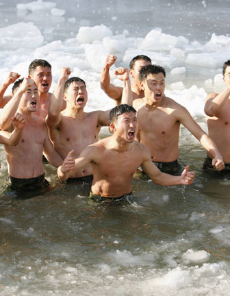 Members of the Special Warfare Command take a cold bath during an annual severe winter season drill in Pyongchang, about 180km (113 miles) east of Seoul, January 10, 2007. The special forces carry out the training course every year to improve their member's combat abilities in the cold weather and heavy snowfall.