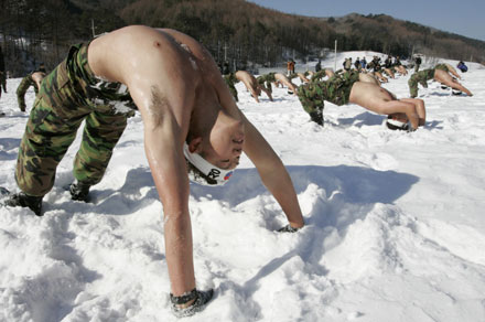 Members of the Special Warfare Command stretch out on snow during an annual severe winter season drill in Pyongchang, about 180km (113 miles) east of Seoul, January 10, 2007. The special forces carry out the training course every year to improve their member's combat abilities in cold weather and heavy snowfall.