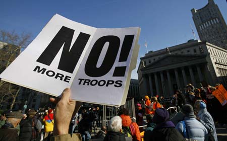 A demonstrator holds a sign during the International Day to Shut Down Guantanamo protest, in New York January 11, 2007. Anti-war and human rights groups demonstrated in Manhattan and around the country to close the U.S.-run prison in Guantanamo Bay on the fifth anniversary since the U.S. first transferred men to the prison. 