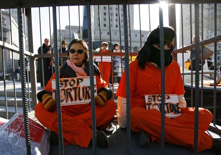 Demonstrators sit in a cage during the International Day to Shut Down Guantanamo protest, in New York January 11, 2007. Anti-war and human rights groups demonstrated in Manhattan and around the country to close the US-run prison in Guantanamo Bay on the fifth anniversary since the US first transferred men to the prison. 