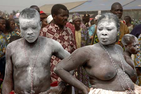 Voodoo practitioners chant and dance to African drums during the Voodoo Day celebrations in Ouidah January 10, 2007. Thousands of people from all over Benin gather in Ouidah, a former slave port on the Atlantic Ocean, 40 km (25 miles) from Cotonou, Benin's capital city, revered as the cradle of voodoo and offer prayers and sacrifices to their gods. About 60% of the country's 6.3 million people practice voodoo. Picture taken January 10, 2007.