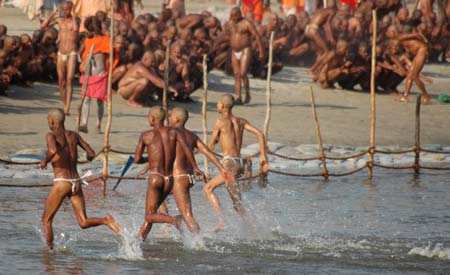 Naga Sadhus (holy men) run through the waters of river Ganges during Ardh Kumbh Mela or Half Pitcher festival in Allahabad January 16, 2007. 
