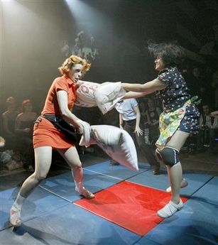 Polly Esther (L) gets slugged by Betty Clock'er during an elimination match in the Pillow Fight League (PFL) at a late night event in Toronto, January 12, 2007. Betty Clock'er, who defeated Polly Esther, will challenge the current champion Champain for the title in the league's first live event in the United States in New York City on January 19.