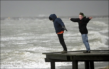 Children play as a storm approaches at the beach in Ijmuiden situated on the North Sea coast in the Netherlands. Severe storms packing hurricane-force winds battered northwest Europe, killing at least 11 people and triggering a dramatic air-sea rescue from a sinking cargo ship in the English Channel.(