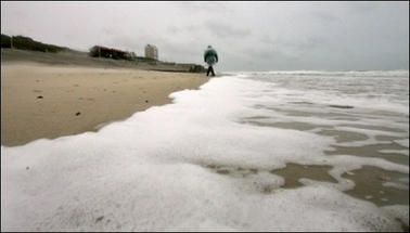 A lone person walks on the beach on the northern German island of Sylt. A severe storm front has battered the British Isles and Germany, causing havoc with shipping and leaving one man dead in England, with forecasters predicting worse weather to come.