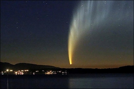 There she goes... : The McNaught comet is seen early morning from Pucon, Calafquen Lake sector, Chile. (AFP/David Lillo) 