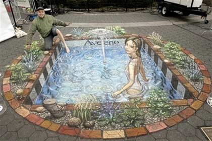 In this photo provide by Aveeno, 3-D artist Julian Beever, from England, pretends to dip his toe into his latest anamorphic creation, the Aveeno Fountain of Youth, in New York's Union Square, Thursday, Jan. 25, 2007. Aveeno commissioned the 'Pavement Picasso's' work in celebration of their new Positively Ageless skin care creams. (AP Photos