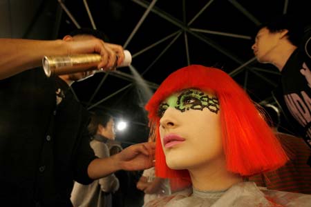 A model has her hair sprayed before Manish Arora's Autumn/Winter 2007 show at London Fashion Week in London February 12, 2007. 