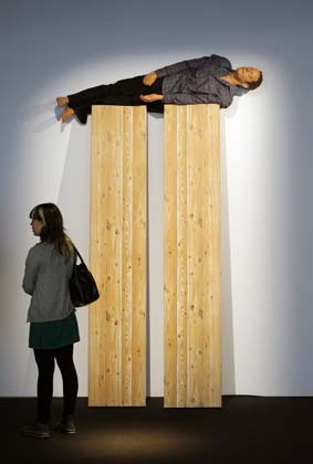 A visitor stands next to an artwork at Madrid's international contemporary art fair ARCO February 14, 2007. This year's edition features the participation of 250 galleries from 30 countries with South Korea being this year's invited country.