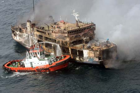 A boat sprays water into the burning ferry Levina I 50 miles from Jakarta's Tanjung Priok Port February 22, 2007. 