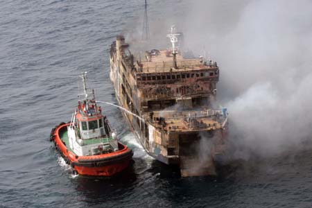 A boat sprays water into the burning ferry Levina I 50 miles from Jakarta's Tanjung Priok Port February 22, 2007. 
