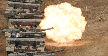 South Korea's K-1 tanks conduct shooting drills at a shooting range about 15 km (9.3 miles) south of the demilitarized zone separating two Koreas and about 40 km (25 miles) north of Seoul, in Paju March 14, 2007. 