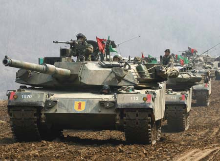 South Korea's K-1 tanks and soldiers participate in shooting drills at a shooting range about 15 km (9.3 miles) south of the demilitarized zone separating the two Koreas and about 40 km (25 miles) north of Seoul, in Paju March 14, 2007. 