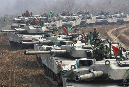South Korea's K-1 tanks and soldiers participate in shooting drills at a shooting range about 15 km (9.3 miles) south of the demilitarized zone separating the two Koreas and about 40 km (25 miles) north of Seoul, in Paju March 14, 2007. 