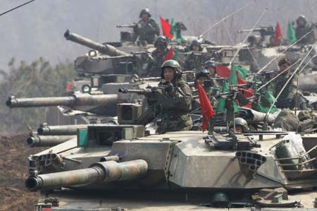 South Korea's K-1 tanks and soldiers participate in shooting drills at a shooting range about 15 km (9.3 miles) south of the demilitarized zone separating the two Koreas and about 40 km (25 miles) north of Seoul, in Paju March 14, 2007. 