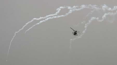 A U.S. Apache helicopter fires flares while patrolling over Baghdad March 15, 2007.
