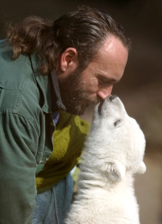 Berlin zoo employee Thomas Doerflein plays with polar bear cub Knut during the bear's first presentation in Berlin zoo, March 23, 2007. Knut, born on December 5, 2006, had to be hand fed every four hours by Doerflein after its mother Tosca refused the baby. 